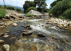 Rip-rap (boulders and cobbles) laid at the channel base