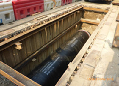Pipe laying in an open trench excavation under the temporary traffic arrangement (TTA) at Cheung Tung Road