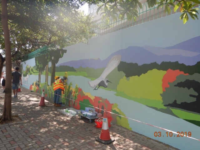 The local artist is painting the wall