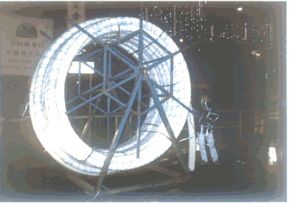A reel of folder liner being inserted into a pipe through a machine